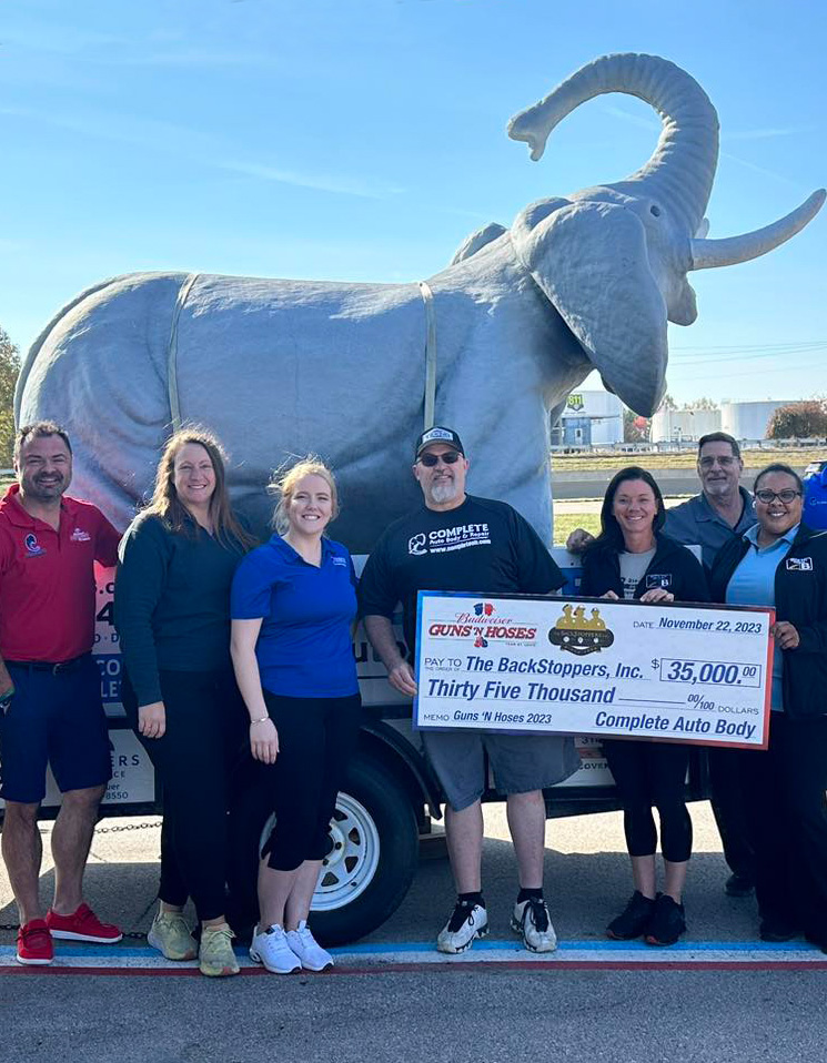 Complete Auto Body crew with $35,000 check for Backstoppers