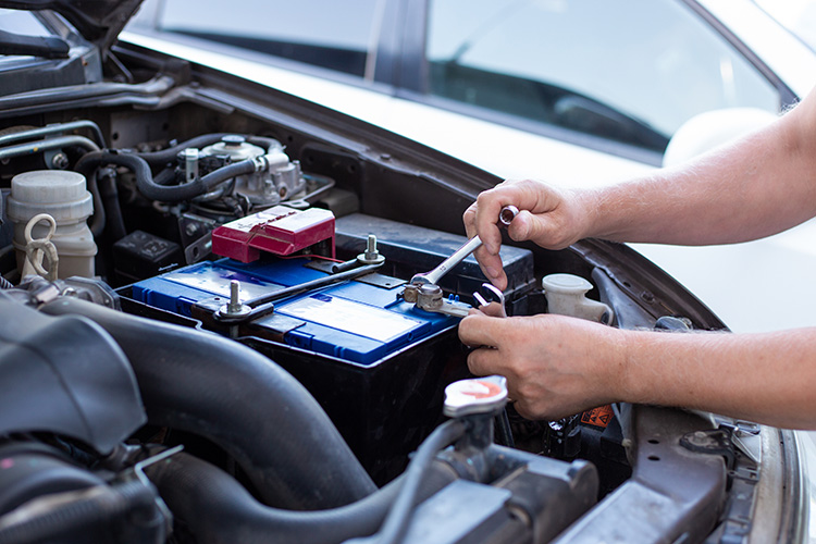 mechanic installing a new car battery
